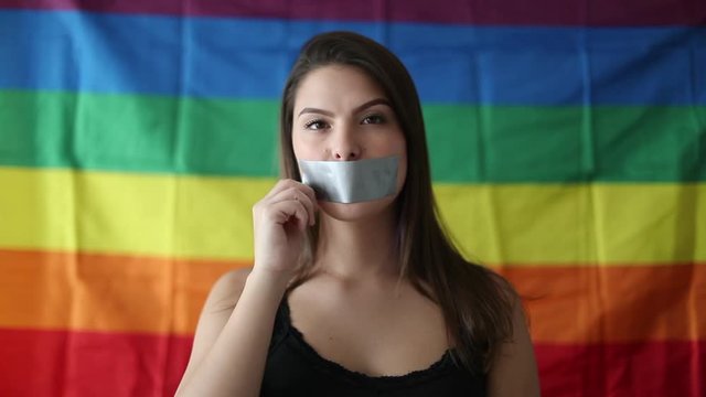 Woman taking off tape with over mouth, democracy LGBT freedom concept