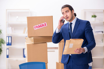 Young male logistics specialist working in the office