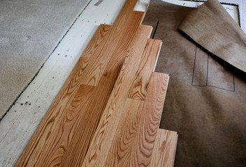 Renovation of home floor with exposed plywood and old carpet with new oak boards