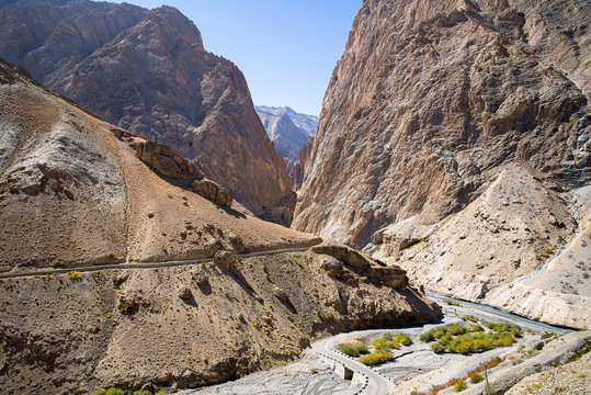 Road to Kanji Ladakh India through steep rocky mountains river and aqueduct
