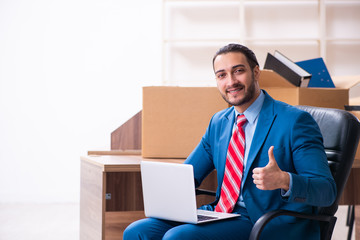 Young male employee in relocation concept