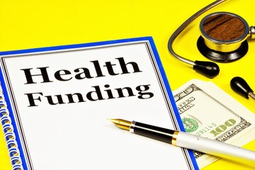 Health care financing-text inscription on a form on a Notepad. Supply of money, financial resources on a paid or unpaid basis, credit, subsidy.