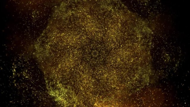 Elegant, detailed, and golden particles flow with shallow depth of field underwater.Gold ink in water shooting with high speed camera. Golden glitter sand or dust creating abstract cloud..