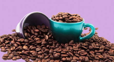 Cups of coffee with beans in and spilled around with pastel background