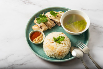 Hainanese chicken with a bowl of soup
