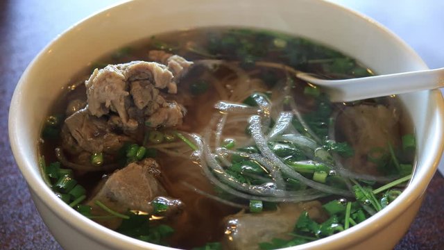 Close up shot of a bowl of delicious Oxtail Pho