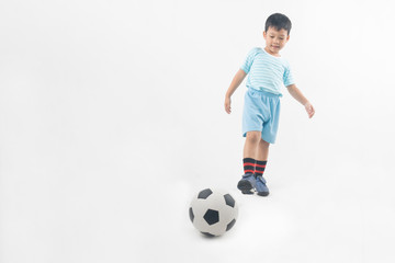 Young Asian boy kick football isolated on white background