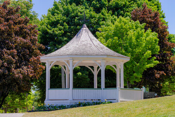 White gazebo (bandstand) along  Niagara River during summer, in Queen's Royal Park