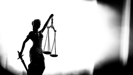 Legal law background image with scales of Justice silhouette on white background.