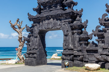 Gate to popular Melasti Beach (Pantai Melasti), Bukit, Bali, Indonesia. Turquoise water, ocean...