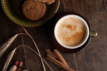 Cup of cofee and cereal cookies on the old wooden table