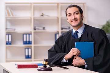 Young male judge working in courthouse