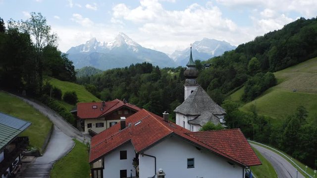 Aerial fly near church Maria Gern on sunny day, Mount Watzmann in background, Berchtesgaden, Bavaria, Germany, Europe