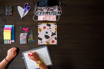 Back to School, stationery items display pencils, pen, scissiors, face mask, colour, pins