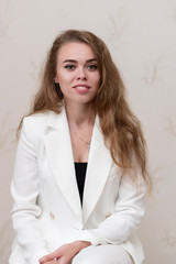 Portrait of a girl in a white suit.