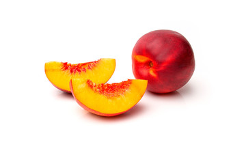 Peach or nectarine with cut pieces on white background