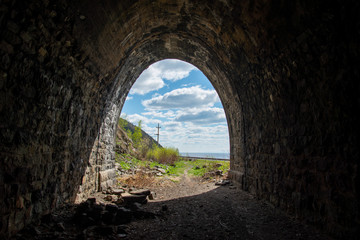 Fototapeta premium Old tunnel on Circum-Baikal Railway, lake Baikal. Baikal. View from one tunnel to other tunnel. Circum-Baikal Railway. Irkutsk region.