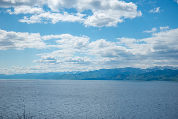 The coast of Lake Baikal on the Circum-Baikal Railway. Circum-Baikal railway tour in Siberia with trees, cliffs and mountains at coast. 
Baikal.
