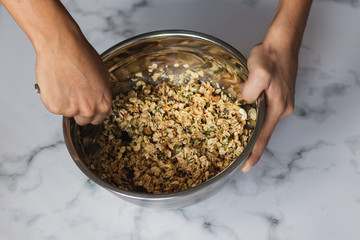 Closeup shot of a chef preparing an oat and nut mixture for breakfast