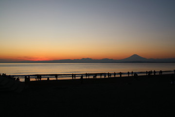 Fototapeta na wymiar 江ノ島海岸から見る夕日と富士山
