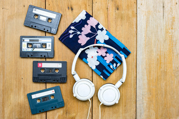 Top view Cassette tape and head phone laying on wood board