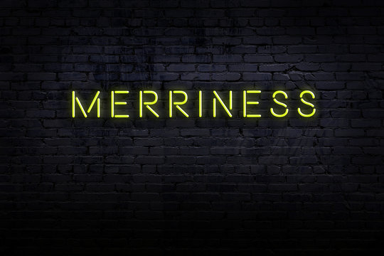 Night view of neon sign on brick wall with inscription merriness