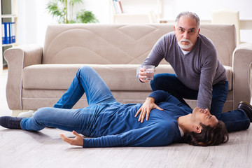 Grandfather and grandson in first aid concept