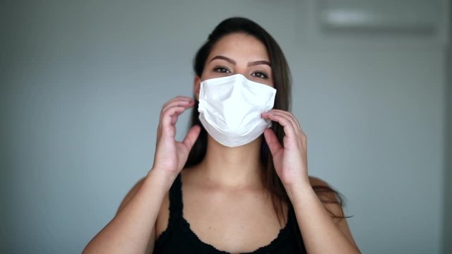 Young woman removing surgical pandemic mask feeling relief