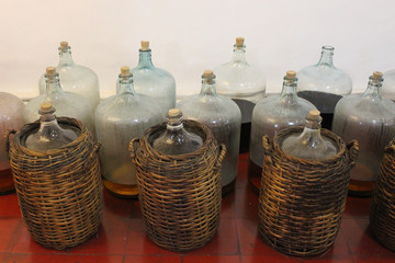 Big jar bottle storage in brown weave basket