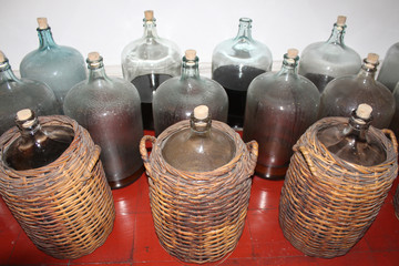 Big jar bottle storage in brown weave basket