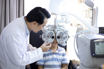 optometrists are examining pediatric patients' eyes with the Autorefractor
