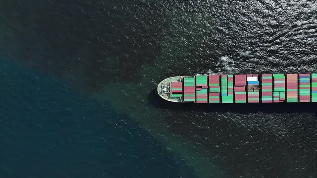 Aerial top view of cargo ship carrying container and running for export  goods  from  cargo yard port to custom ocean concept freight shipping by ship .