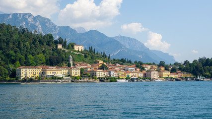 Fototapeta na wymiar Bellagio, Italy. Amazing view of the village from the boat. Bellagio one of the most famous Italian place in the world. Best of Italy. Como lake. traditional Italian landscape. Summer time