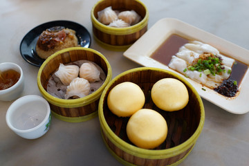 Variety of Chinese Dim Sum for breakfast. Dim Sum in bamboo steamer, traditional Chinese cuisine.