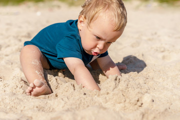 Little boy playing in the sandy Baltic sea beach. Post Quarantine family vacation in native resort.
