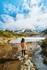 Asian woman is standing at swamp that is named Midorigaike in Tateyama-Kurobe alpine route or Japan Alps in Toyama, Japan