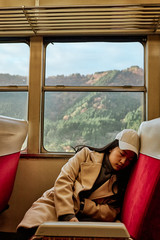 Asian woman is sleeping while is traveling.