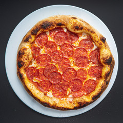 pizza on the black background, top view