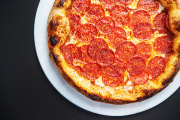 pizza on the black background, top view