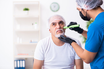 Old man visiting male doctor for plastic surgery