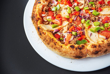 pizza on the black background, top view
