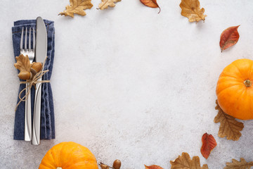 Fall season background with cutlery, leaves and pumpkins.