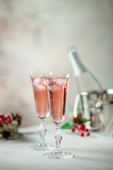 Two glasses of  champagne on light background. Festive drink. Valentins or Christmas concept.