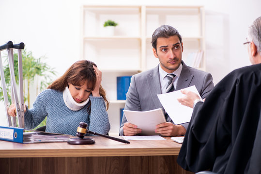 Young woman in courthouse with judge and lawyer