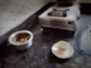 Defocused empty cup of tea on floor of kitchen