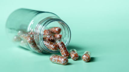 Capsule multivitamins and supplements with fresh and healthy fruits on green background, Close up vitamins and supplements with bottle, Including vitamin pills for healthy eyes.