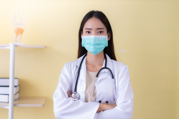 Medicine and health care concept.  Asian doctor  woman in hospital.doctor or nurse wear protection mask checking and takecare infection people from covid-19 .