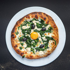 pizza on the black background, top view