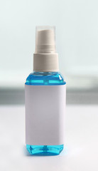 Blue alcohol liquid for medical purpose prevention from coronavirus COVID-19 (Ethanol or ethyl alcohol) in a plastic spray bottle with blank label. Vertical photo
