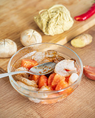 chef making ramen with shrimps and vegetables